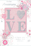 This anniversary card is a gentle celebration of enduring romance, as though carefully selected from a florist's display just moments from St James's Palace. Its colour story is a soothing blend of pastel pinks and silvery greys, balanced with touches of soft white that give the design an air of treasured intimacy. At the centre, the word LOVE is spelled out in raised, glitter-encrusted letters that sparkle delicately rather than boldly. The letter O is replaced by a shimmering silver heart, its textured surface catching the light in subtle flashes, much like the gleam of a polished vase on a mantelpiece. Framing this central motif, a halo of delicate blooms in blush and mauve seems to unfold with watercolour softness. The petals are edged with fine lines, and gentle shading gives each blossom a sense of depth, evoking roses and spring flowers arranged with care. Curving vines, slender stems, and looping tendrils weave through the composition, interspersed with tiny flourishes: scattered petals, whimsical swirls, and almost ghostlike butterflies that add a touch of fantasy. The background remains a muted, powdery pink, allowing the silvery accents and floral shapes to stand forward without feeling crowded. Scripted text reading On Our Anniversary and I love you today and always appears in a delicate, flowing hand, mirroring the organic curves of the vines. The overall impression is of a keepsake moment captured on paper, reminiscent of anniversary flowers delivered across St James's - soft-spoken yet deeply heartfelt, perfect for honouring a shared journey that has weathered seasons and grown more beautiful with time.
